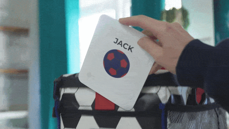 A custom name and football icon card being added to a KitBrix bag
